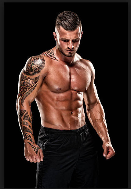 Hunk-O-Mania performer posing under stage lighting
